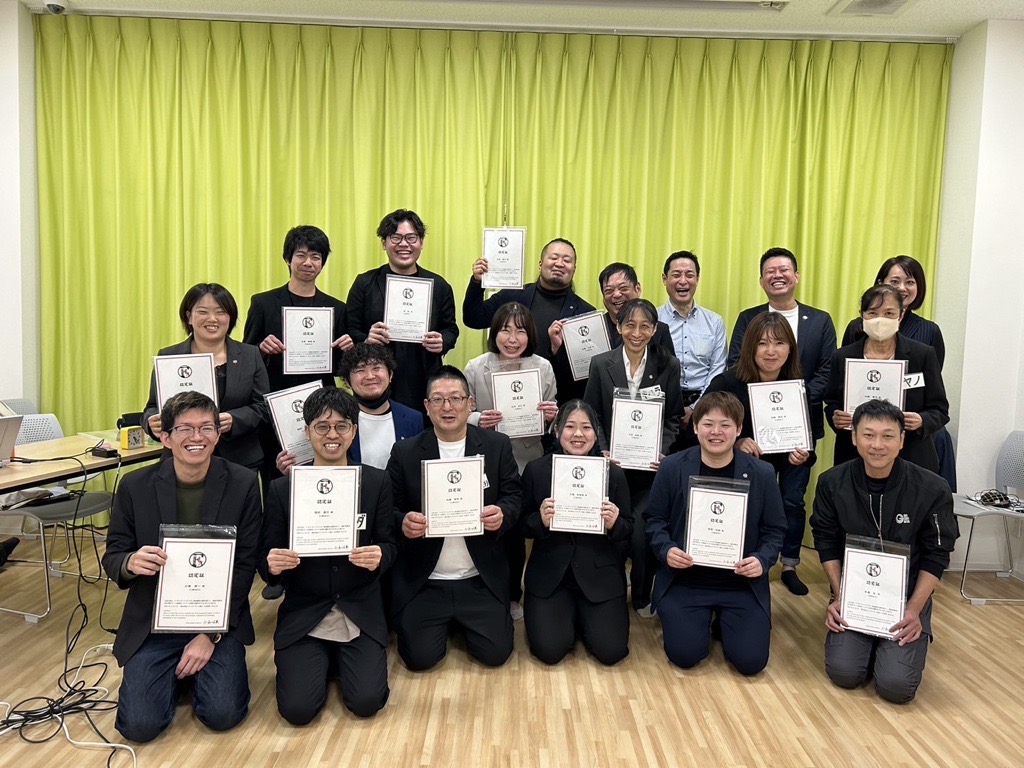 認定証を手にした大勢の受講生